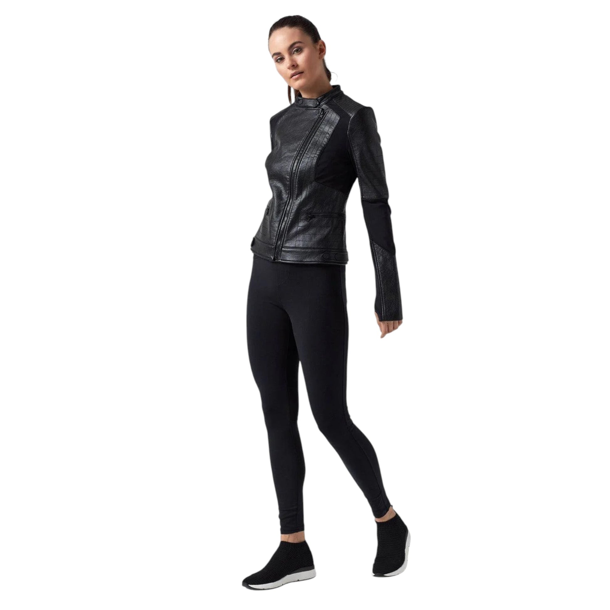 Woman wearing a black leather jacket and leggings on a white background