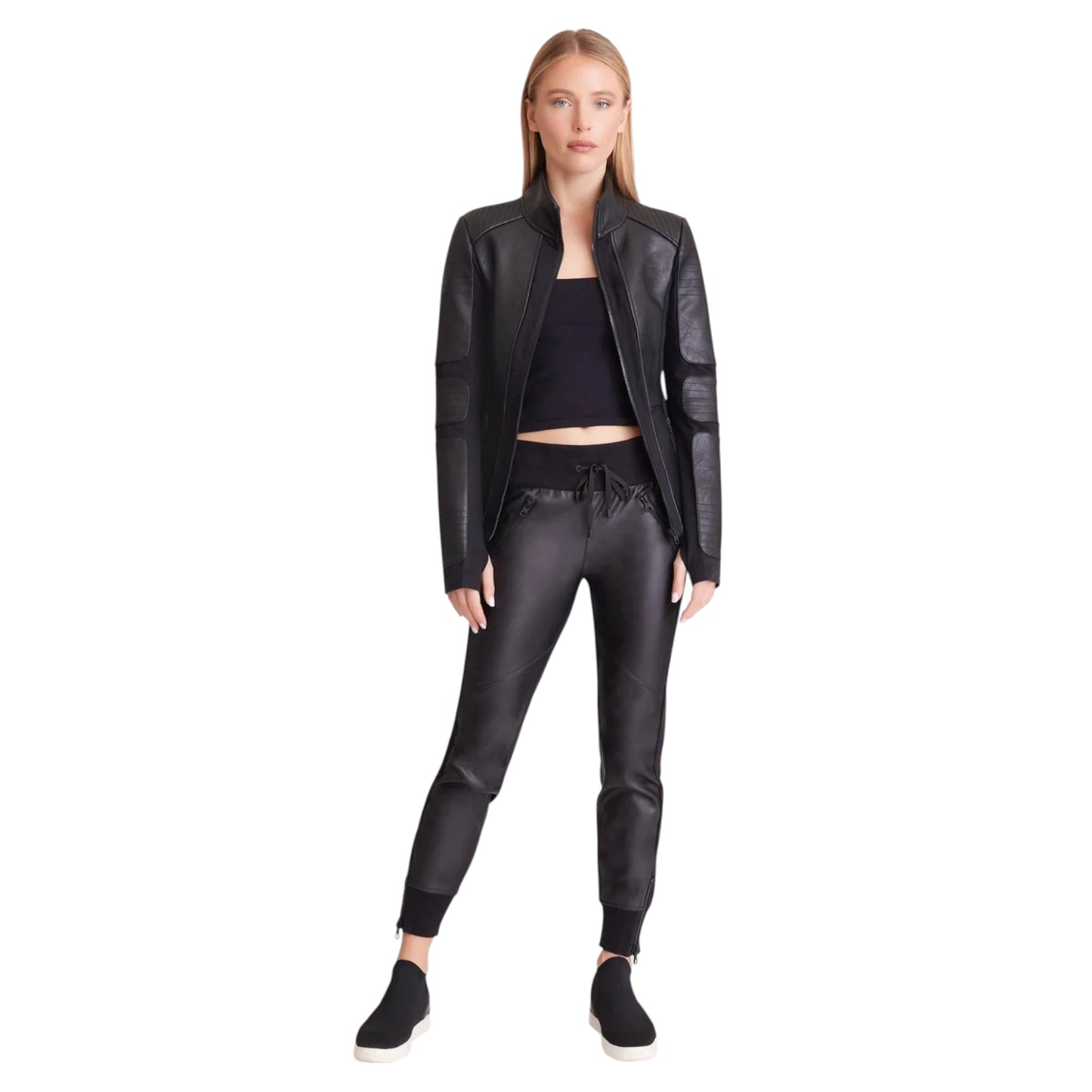 Woman wearing a black leather jacket and pants on a white background