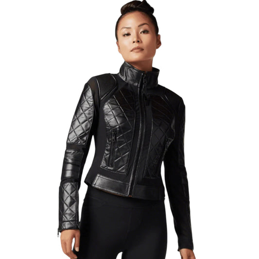 Woman wearing a black quilted jacket on a white background